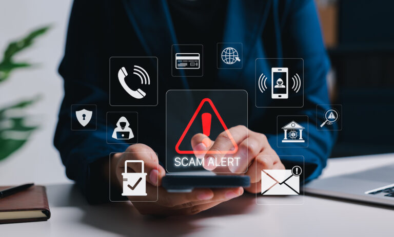 Person holding a smartphone surrounded by floating digital icons, including a phone call, a hooded hacker, a credit card, and a red warning triangle labeled "Scam Alert"
